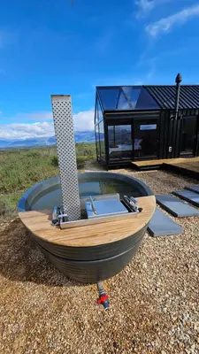 a wooden boat sitting on the ground with a house at Little Acre Luxury Pods in Tulbagh