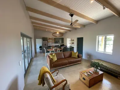 a living room with a couch and a table at Windon vineyard farmhouse in Stellenbosch