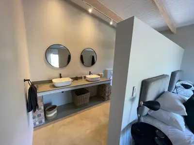 a bathroom with two sinks and two mirrors at Windon vineyard farmhouse in Stellenbosch