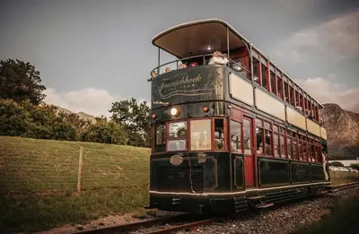 an old double decker trolley on the tracks at Neighbourgood Franschhoek in Franschhoek