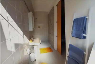 a small bathroom with a sink and a toilet at Birdsong Cottage in Cape Town