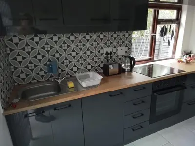 a kitchen with a sink and a counter top at Birdsong Cottage in Cape Town