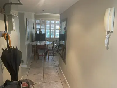 a hallway with a table and a dining room at Central Stellenbosch Apartment, Dorp Street in Stellenbosch