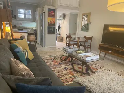 a living room with a couch and a coffee table at Central Stellenbosch Apartment, Dorp Street in Stellenbosch