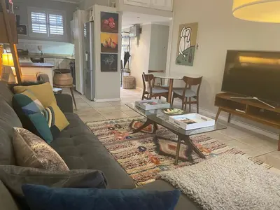 a living room with a couch and a coffee table at Central Stellenbosch Apartment, Dorp Street in Stellenbosch