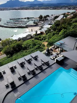 an aerial view of a resort with a swimming pool at Bikini Beach Manor in Gordonʼs Bay