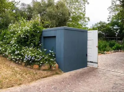 a blue and white shed next to some flowers at Kriluki Accommodation in Stellenbosch