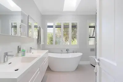a white bathroom with two sinks and a tub at Sunset Spring Villa in Cape Town