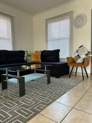 a living room with a couch and a coffee table at The Great escape 5 mins away from Blouberg Beach in Cape Town