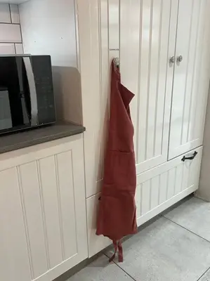 a kitchen with a red apron hanging on a wall at 7de Hemel Paarl in Paarl