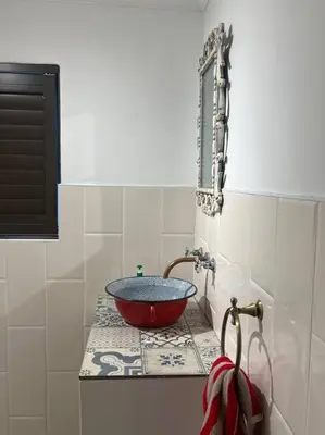 a bathroom sink with a red bowl on a counter at 7de Hemel Paarl in Paarl