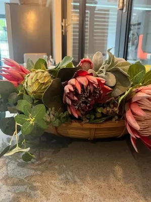 a basket filled with flowers and plants on a floor at 7de Hemel Paarl in Paarl