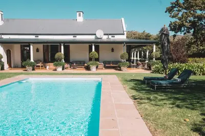 a swimming pool in the yard of a house at La Clé Village in Franschhoek