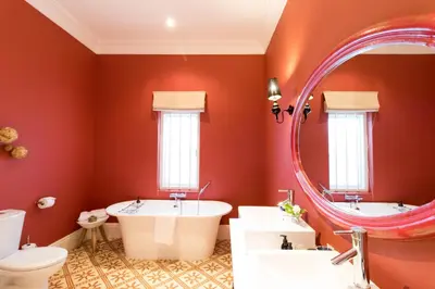 a bathroom with two sinks and a large mirror at La Clé Village in Franschhoek