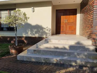 a set of stairs leading to a wooden door at Ringwood Villa in Cape Town