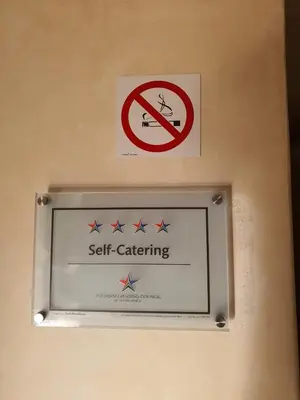 a sign on a wall with a sign that says self catering at Ringwood Villa in Cape Town
