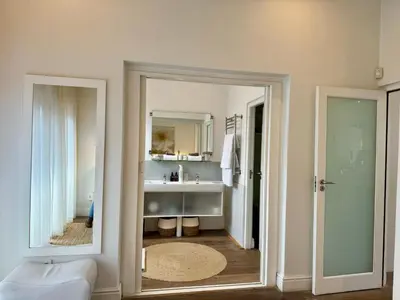 a bathroom with a sink and a mirror at Tuishuisie in Stellenbosch