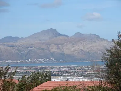 a view of a city and a lake and mountains at Majorca House in Somerset West