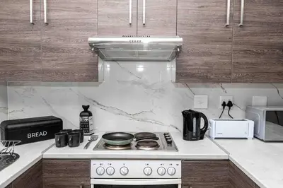a kitchen with a stove and a counter top at Century On Lake Apartment in Cape Town
