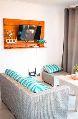 a living room with a couch and a tv at MarineView Getaway in Hermanus
