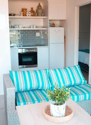 a living room with a couch and a table at MarineView Getaway in Hermanus