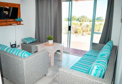 a living room with two chairs and a table at MarineView Getaway in Hermanus