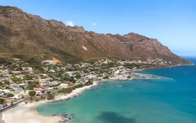 an aerial view of a beach with a mountain at 'Harbour Views' - 2 bedroom, sleeps 4 with private pool and large veranda! in Gordonʼs Bay