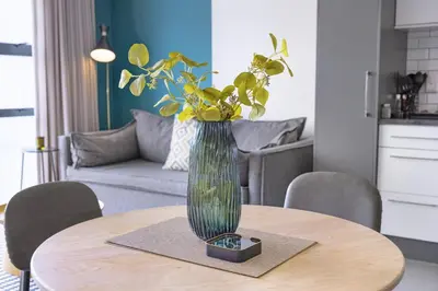 a vase of flowers sitting on a table at The Terraces 330 by Host Agents in Cape Town