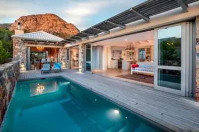 a house with a swimming pool and a patio at Grandeur in Hermanus