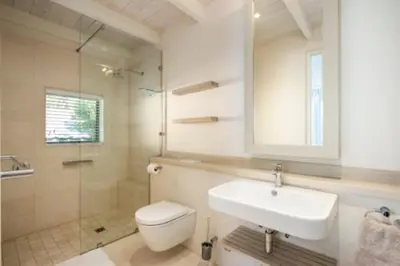 a bathroom with a sink and a toilet and a shower at Grandeur in Hermanus