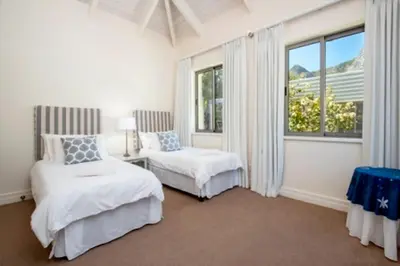 a bedroom with two beds and a window at Grandeur in Hermanus