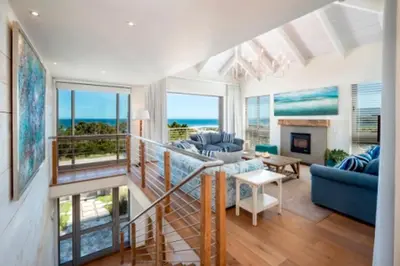 a living room with a view of the ocean at Grandeur in Hermanus