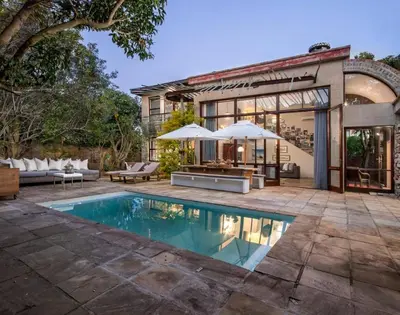 an exterior view of a house with a swimming pool at Two Bedroom Soutpan Apartment in Hermanus