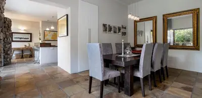 a dining room with a table and chairs at Two Bedroom Soutpan Apartment in Hermanus