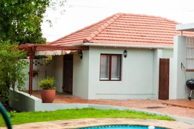 a small white house with a red roof at 3 on The Fairway Pinelands in Cape Town