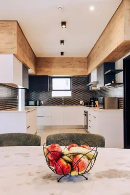a kitchen with a bowl of fruit on a table at Phoenix Home in Cape Town