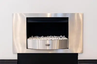 a metal fireplace with rocks inside of it at Phoenix Home in Cape Town