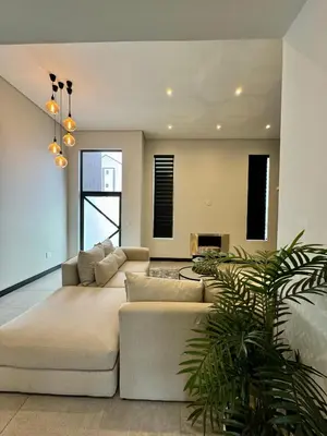 a living room with a couch and a table at Phoenix Home in Cape Town