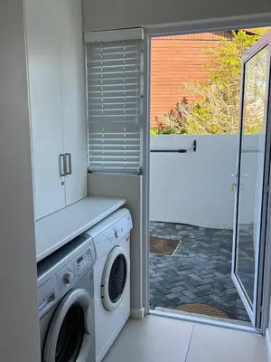 a washer and dryer in a room with a sliding glass door at Views galore in Kleinmond in Kleinmond