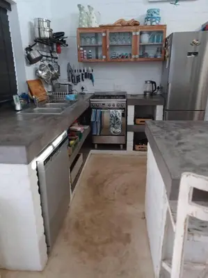 a kitchen with a counter top and a refrigerator at Chillilabombwe in Pringle Bay