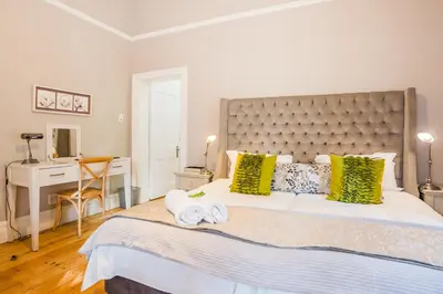 a bedroom with a large bed with two towels at Bonne Esperance Studio Apartments in Stellenbosch