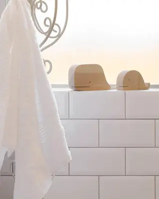 a white towel hanging on a shelf in a bathroom at Rocky Bay on the View in Gordonʼs Bay