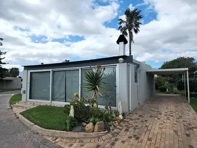 a house with a garden in front of it at Seaside Charm in Gordonʼs Bay