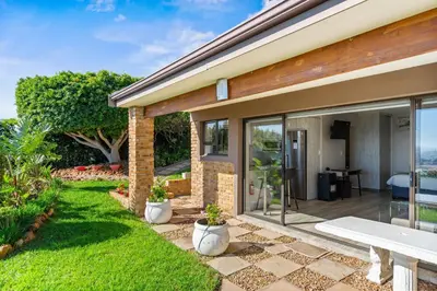 a home with a patio with a view at Zaria Sun Cottage in Gordonʼs Bay
