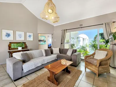 a living room with a couch and a table at Strand Boat House in Cape Town