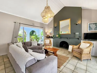 a living room with a couch and a fireplace at Strand Boat House in Cape Town
