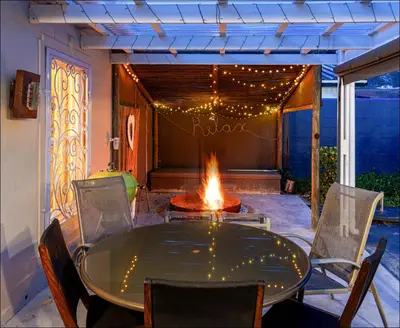 a patio with a table and a fire pit at Pelicans Nest in Onrus in Hermanus