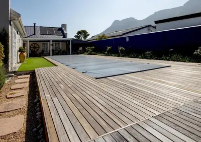 a deck in a yard with a house at Pelicans Nest in Onrus in Hermanus