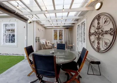 a dining room with a table and chairs at Pelicans Nest in Onrus in Hermanus