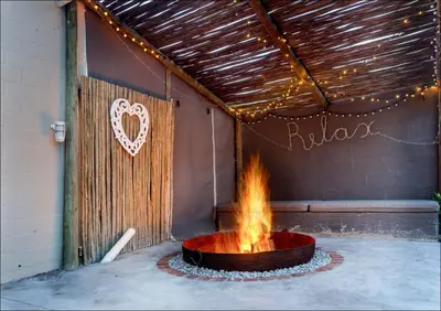 a fire pit in a room with a heart on the wall at Pelicans Nest in Onrus in Hermanus